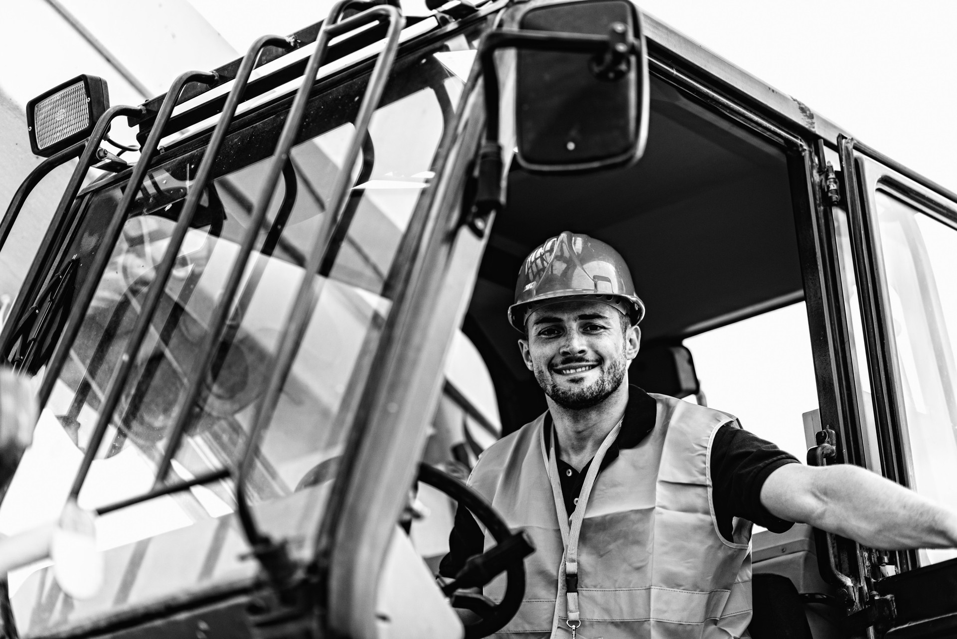 Low Angle Portrait Of Manual Worker Sitting In Truck